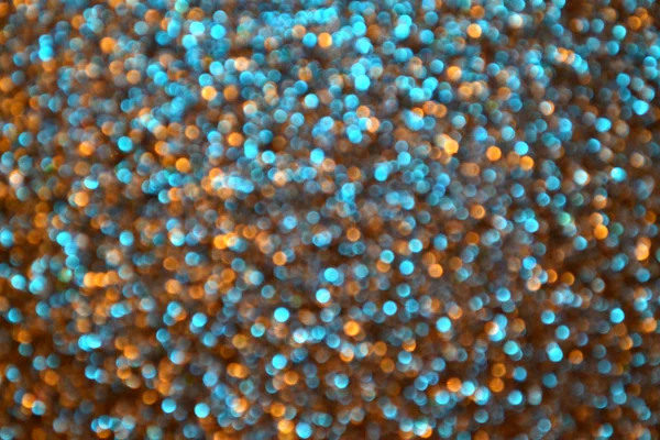 Étoile floue lumineuse et abstraite fond doré et bleu avec des paillettes chatoyantes — Photo