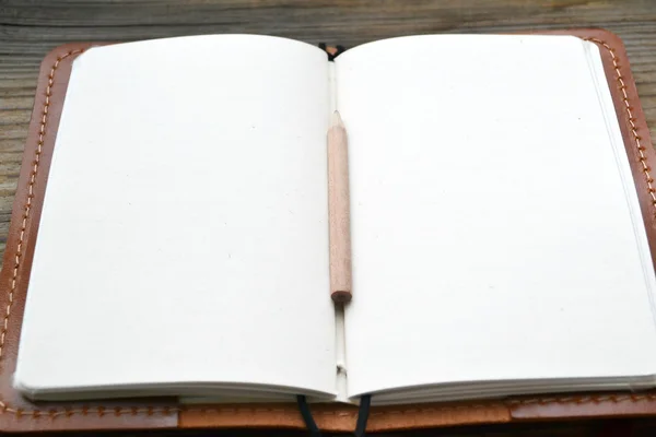 An empty retro notebook with old paper, little pencil and leather cover — Stock Photo, Image