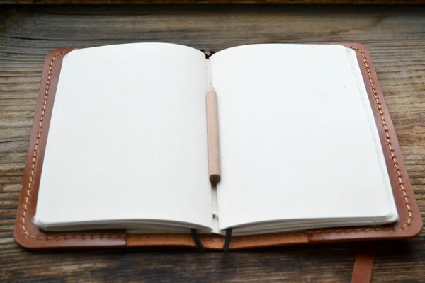 An empty retro notebook with old paper, little pencil and leather cover — Stock Photo, Image