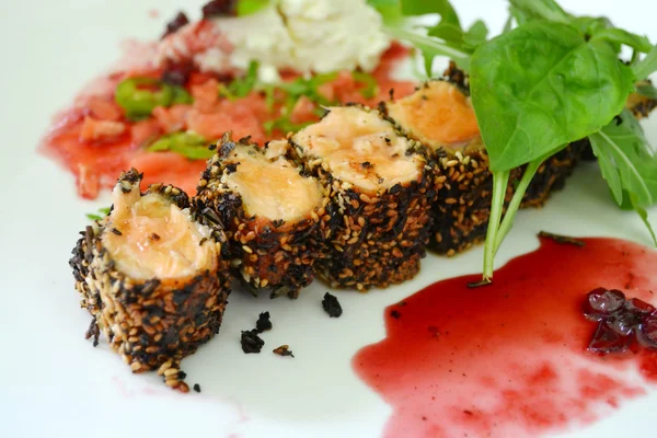 Tasty sushi rolls made of roasted salmon and sesame — Stock Photo, Image