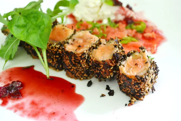 Tasty sushi rolls made of roasted salmon and sesame — Stock Photo, Image