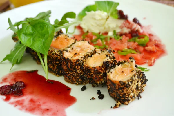 Tasty sushi rolls made of roasted salmon and sesame — Stock Photo, Image