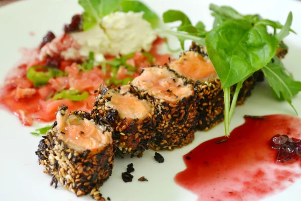 Tasty sushi rolls made of roasted salmon and sesame — Stock Photo, Image
