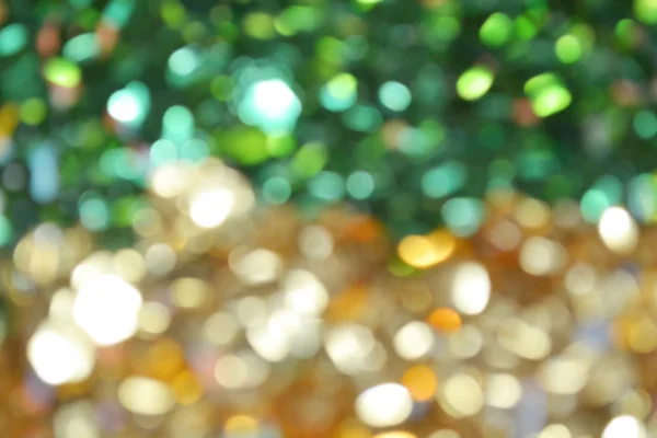 Helder en abstracte wazig groene en gouden achtergrond met glinsterende glitter — Stockfoto