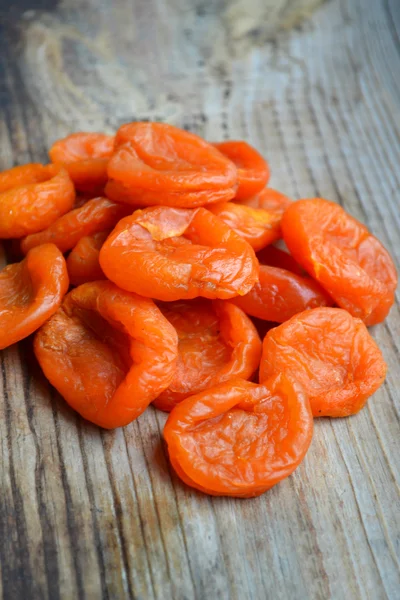 Dried apricots on wooden table — Stock Photo, Image