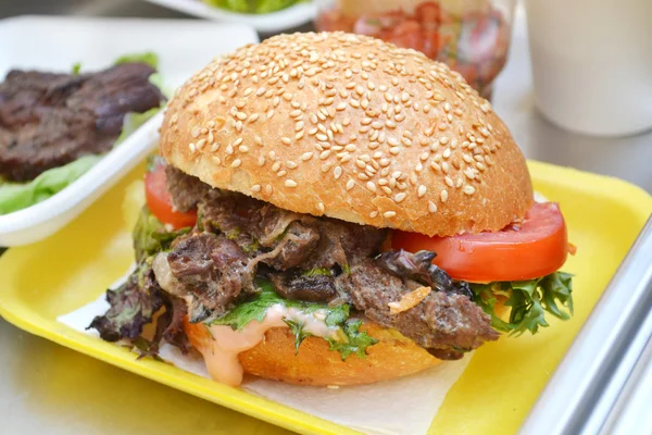 Tasty burger with meat, salad and tomato — Stock Photo, Image