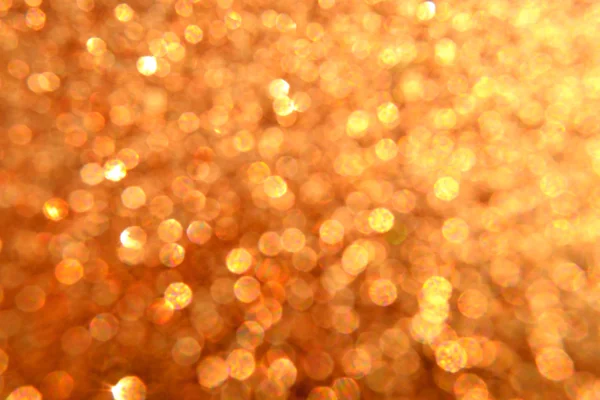Яркий и абстрактный размытый золотой фон звезды с мерцающими блестками — стоковое фото