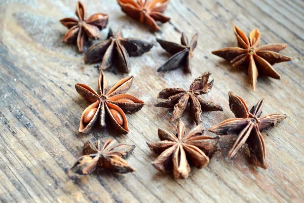 Spicy anise stars on wooden table — Stock Photo, Image