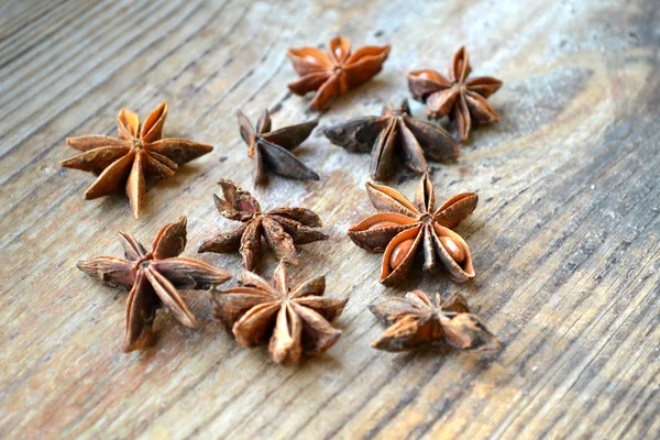 Spicy anise stars on wooden table — Stock Photo, Image