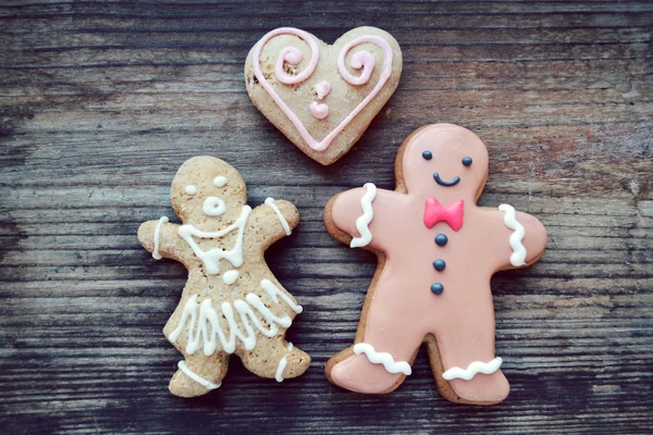 Gingerbread cookies in shape of heart and ginger man on wooden table — Stock Photo, Image