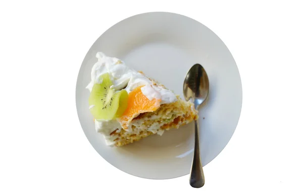 Slice of fruit cake with cream, kiwi and orange isolated on white — Stock Photo, Image