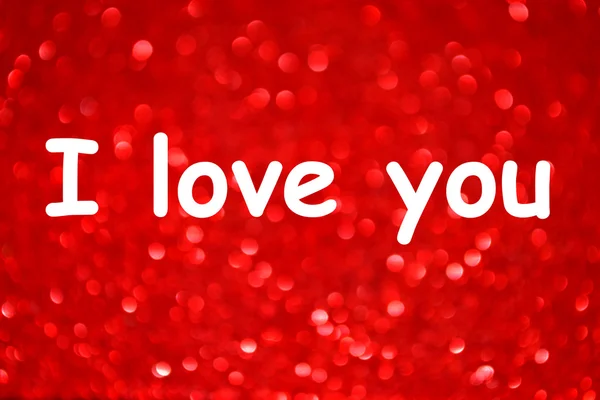 I love you message over bright and abstract blurred red background with shimmering glitter — Stock Photo, Image