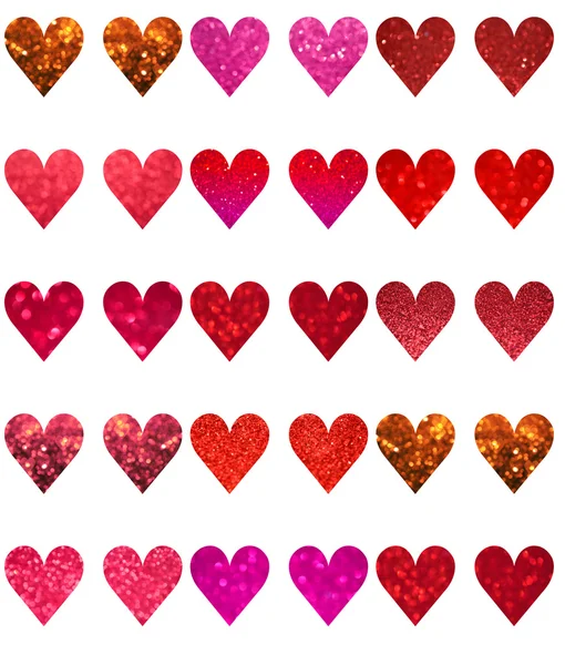 Bright and abstract blurred red, pink and violet hearts with shimmering glitter isolated on white — Stock Photo, Image