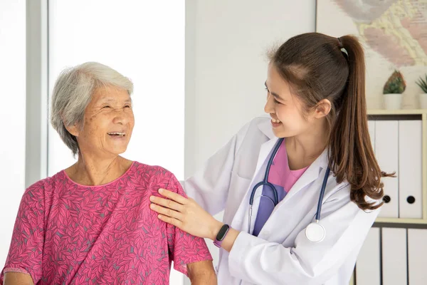 Asian female doctor empowerment to elderly patient, they smiling together, elderly health check up, healthcare and medical concept