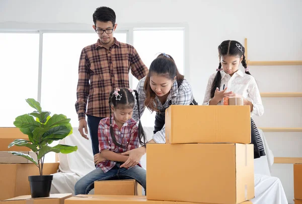 Happy asian family moving the boxes to new house, moving concept