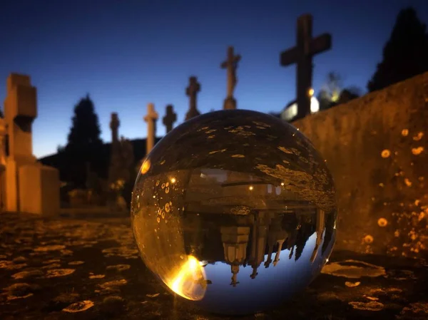 Cemetery crosses in crystal ball — Stock Photo, Image