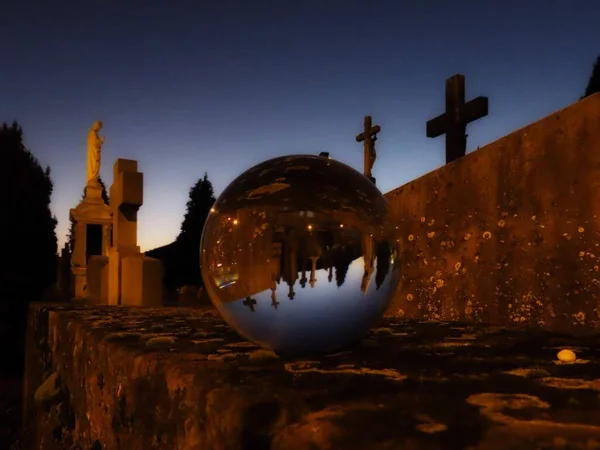 Cemetery crosses in crystal ball — Stock Photo, Image