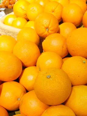 Abundant Display of Brightly Colored Sunkist Oranges Piled High in a Fruit Market