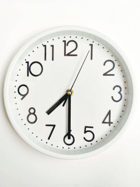 Modern White Wall Clock Showing Half Past Seven