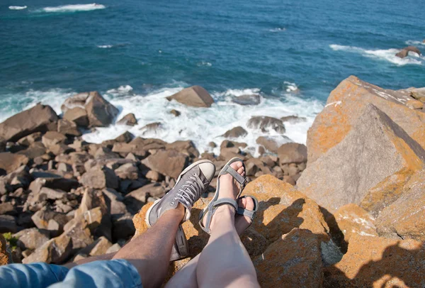 Couple in love sitting on rocks