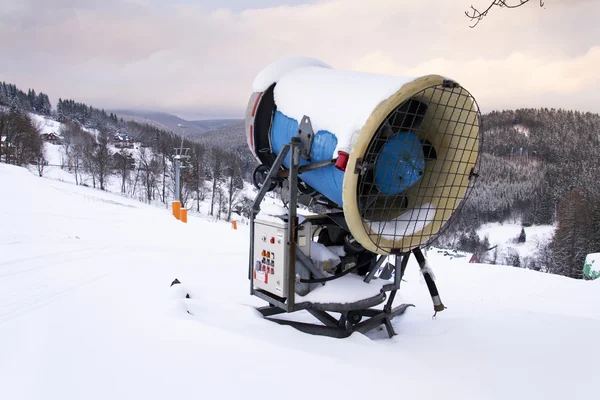 Snow making machine on piste at ski resort in snowy country — Stock Photo, Image