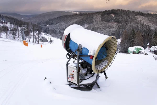 Snow making machine on piste at ski resort in snowy country — Stock Photo, Image