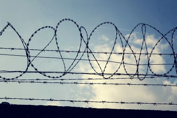 Filtered vintage picture of barbed wire fence — Stock Photo, Image