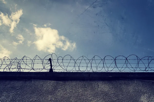 Filtered vintage picture of barbed wire prison fence — Stock Photo, Image