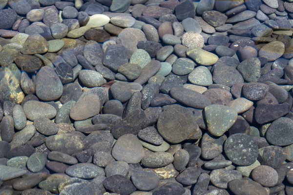 Picture full of stone pebbles under water lake bed background — Stock Photo, Image