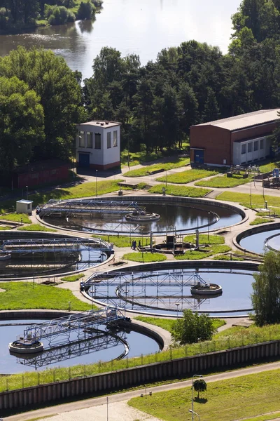 Men checking water storage tanks at sewage treatment plant — Stock Photo, Image