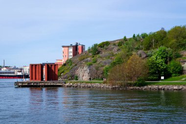İnsanlar 13 Mayıs 2025 'te İsveç' in Göteborg şehrinde Eriksberg ve Slottsberget arasındaki Rüzgâr Tapınağı Vindarnas Tempel 'de yürür..