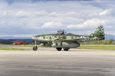 World's first operational jet-powered fighter aircraft Messerschmitt Me-262 Schwalbe rolling on runway clipart