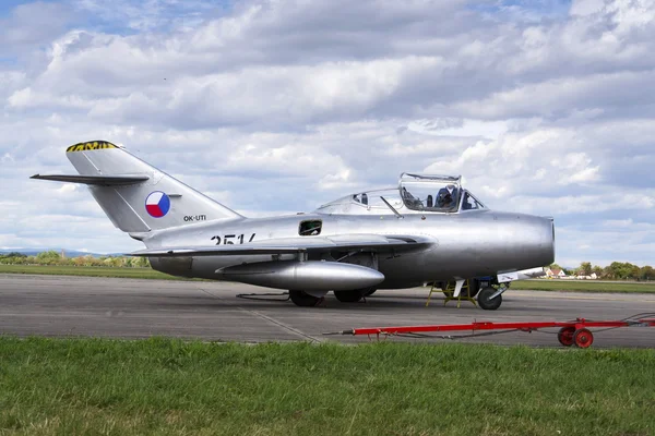 HRADEC KRALOVE, CZECH REPUBLIC - SEPTEMBER 5: Pilot of jet fighter aircraft Mikoyan-Gurevich MiG-15 developed for the Soviet Union standing on runway on September 5, 2015 in Hradec Kralove, Czech repu