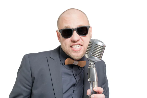 Unshaven bald man with microphone — Stock Photo, Image