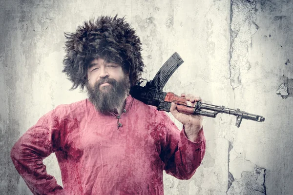 Bearded man with gun — Stock Photo, Image