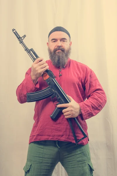 Bearded man with gun — Stock Photo, Image