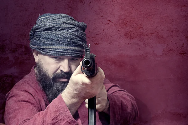 Bearded man with gun — Stock Photo, Image