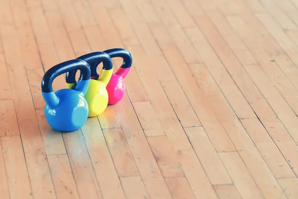 Blue, yellow and pink dumbbells — Stock Photo, Image