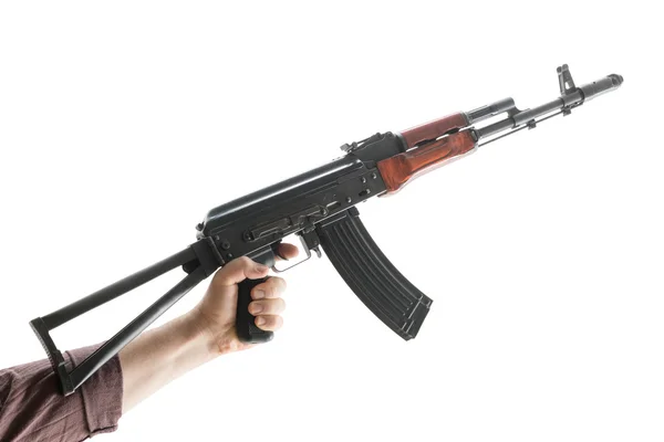 Kalashnikov raised by one hand — Stock Photo, Image