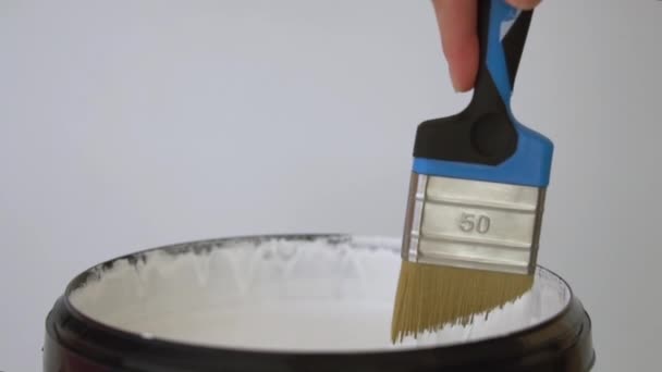 Man Stirring White Paint Bucket Clean Brush — Stock Video