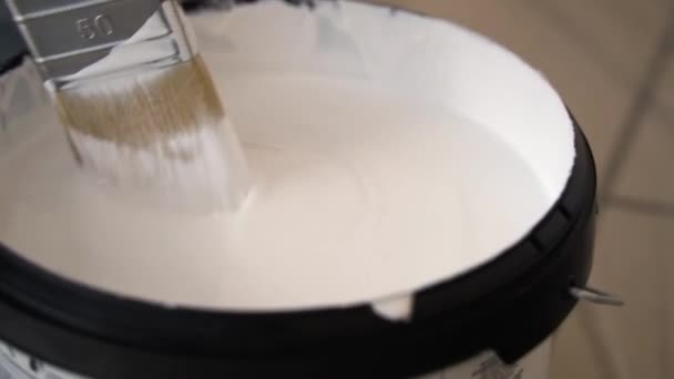Man Stirring White Thick Paint Bucket Wide Brush — Stock Video