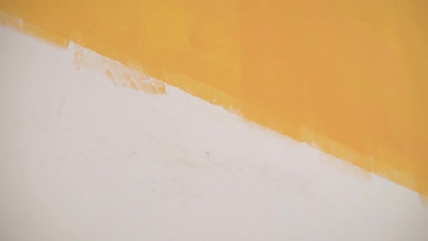 Pige Liggende Smears Orange Maling Væggen Med Børste Kameraet Bevæger – Stock-video