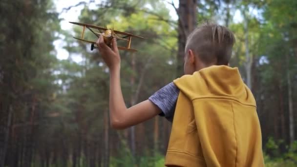 Jongen Rent Met Een Speelgoedvliegtuig Zijn Hand Weg Het Bos — Stockvideo