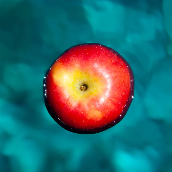 Red apple floating in the water — Stock Photo, Image