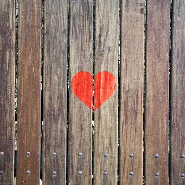 Símbolo rojo del corazón en la textura de madera — Foto de Stock