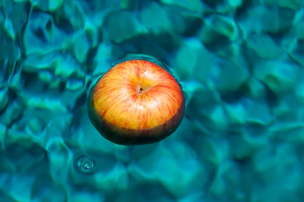 Red apple floating in the water — Stock Photo, Image