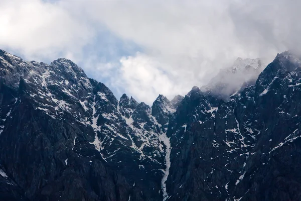Snowy mountains with clouds — Stock Photo, Image