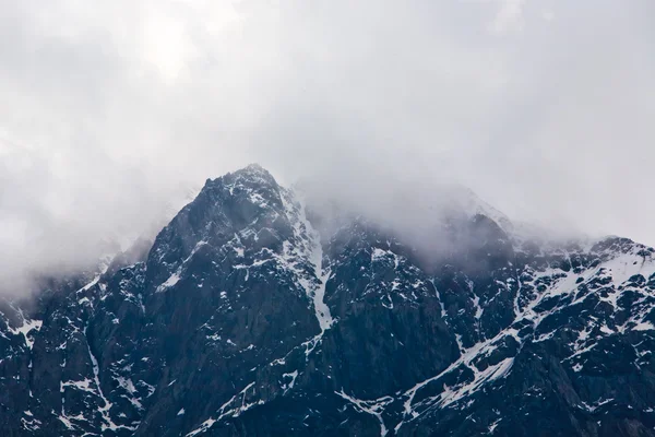 Snowy mountains with clouds — Stock Photo, Image