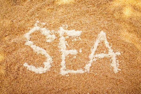 "SEA "testo sulla sabbia — Foto Stock
