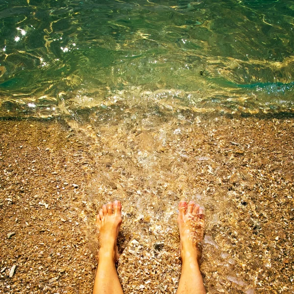 Legs on the sea background — Stock Photo, Image